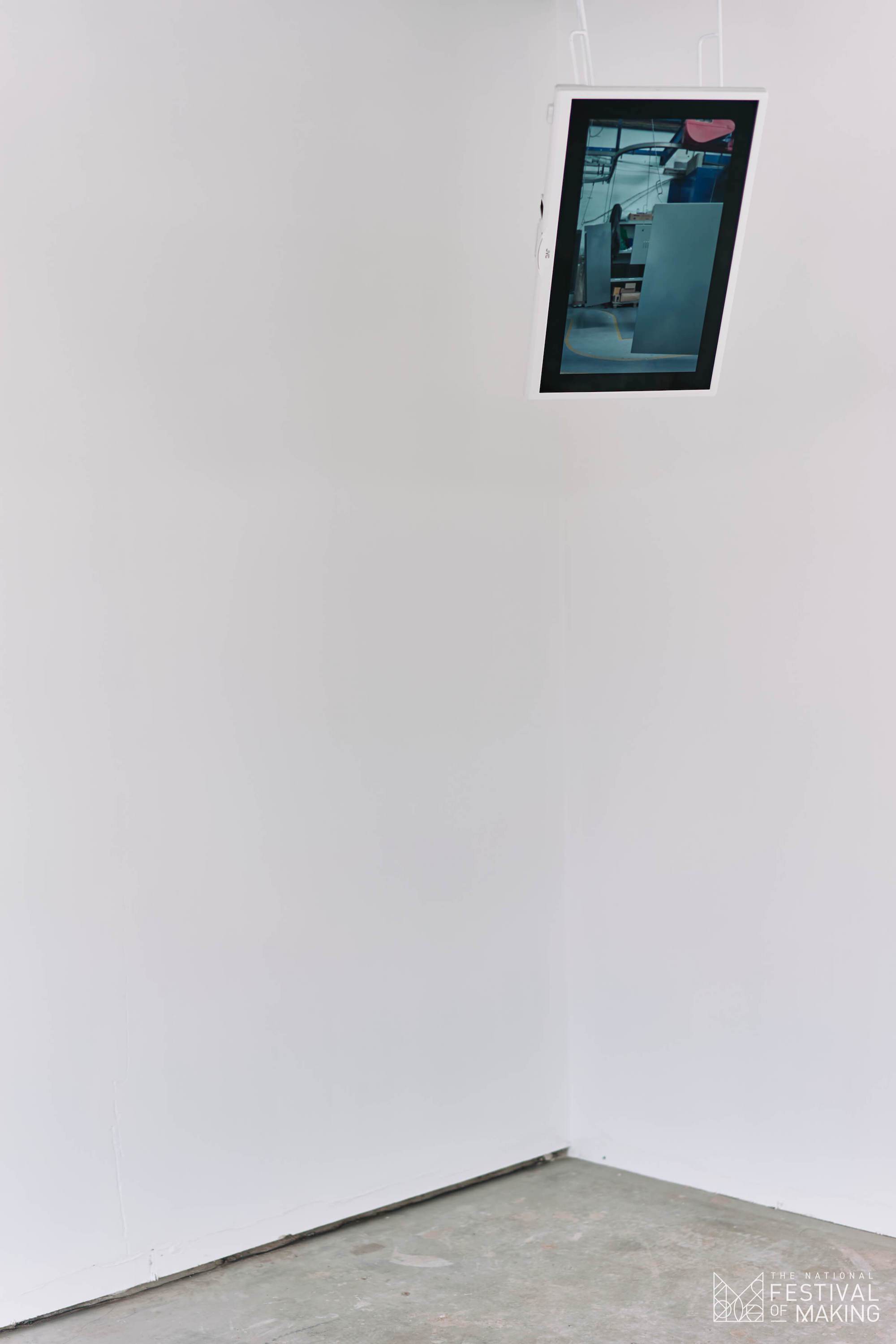Film footage showing freshly powder coated panels suspended by hooks on the paint line. The installation suspends the video on a flat panel tv by the same hooks. Images courtesy of GS Visuals and The National Festival of Making 